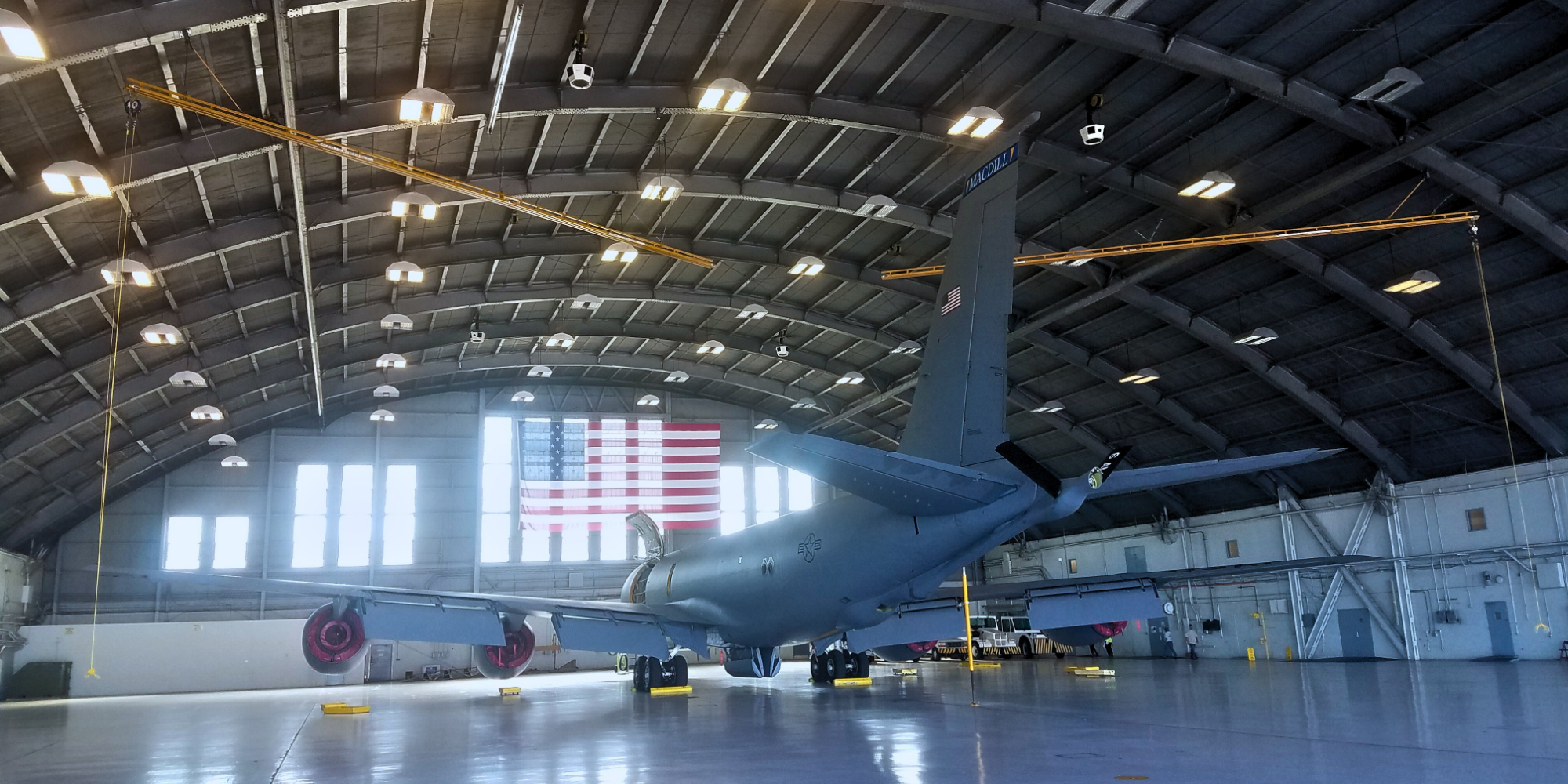 Overhead fall protection system by Evan Fall Protection installed in an aircraft hangar, providing height safety for technicians working on planes during maintenance operations.